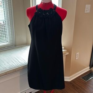 Sleeveless black halter neck sheath cocktail dress.